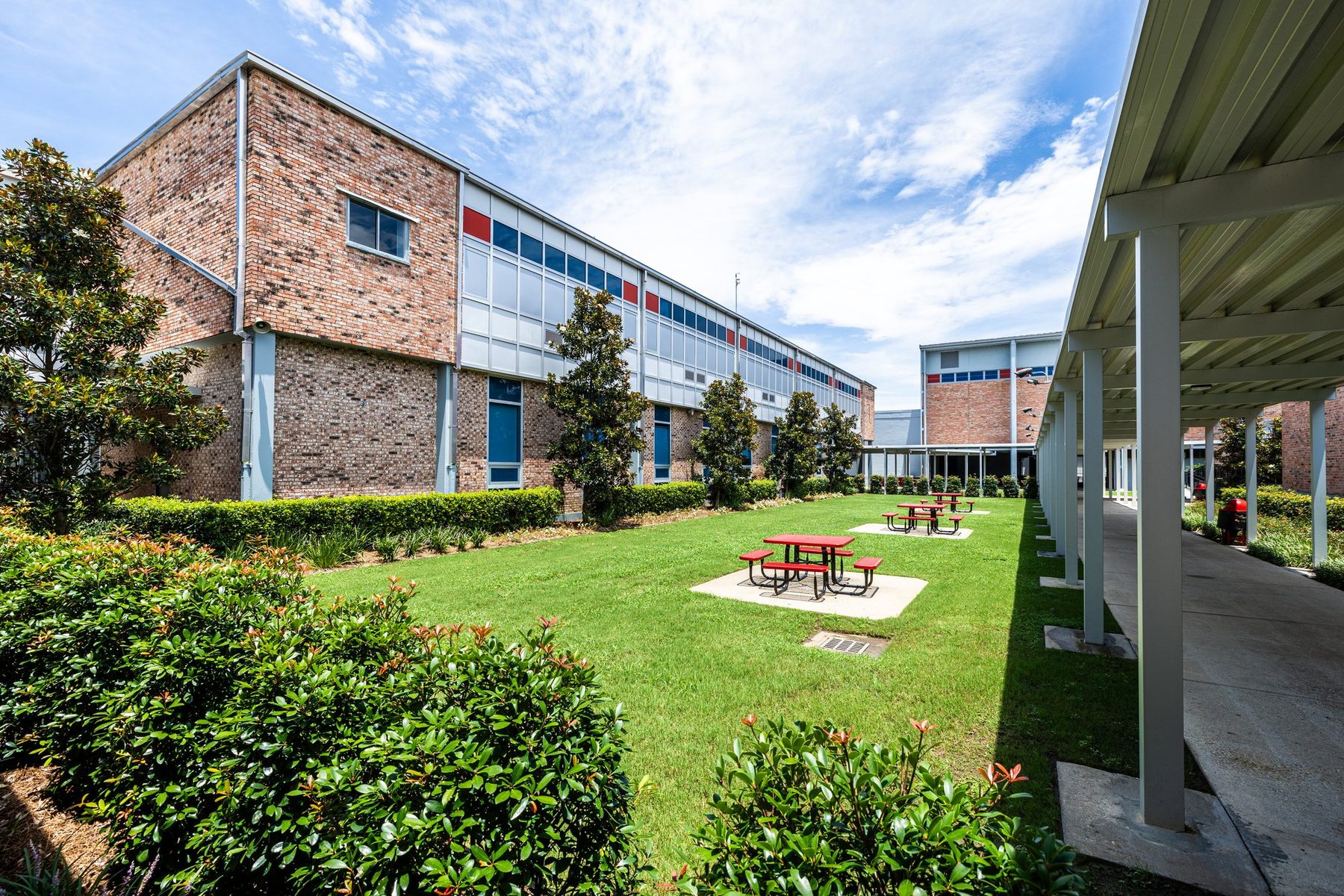 The courtyard from under the walkway, brick buildings and blue sky
