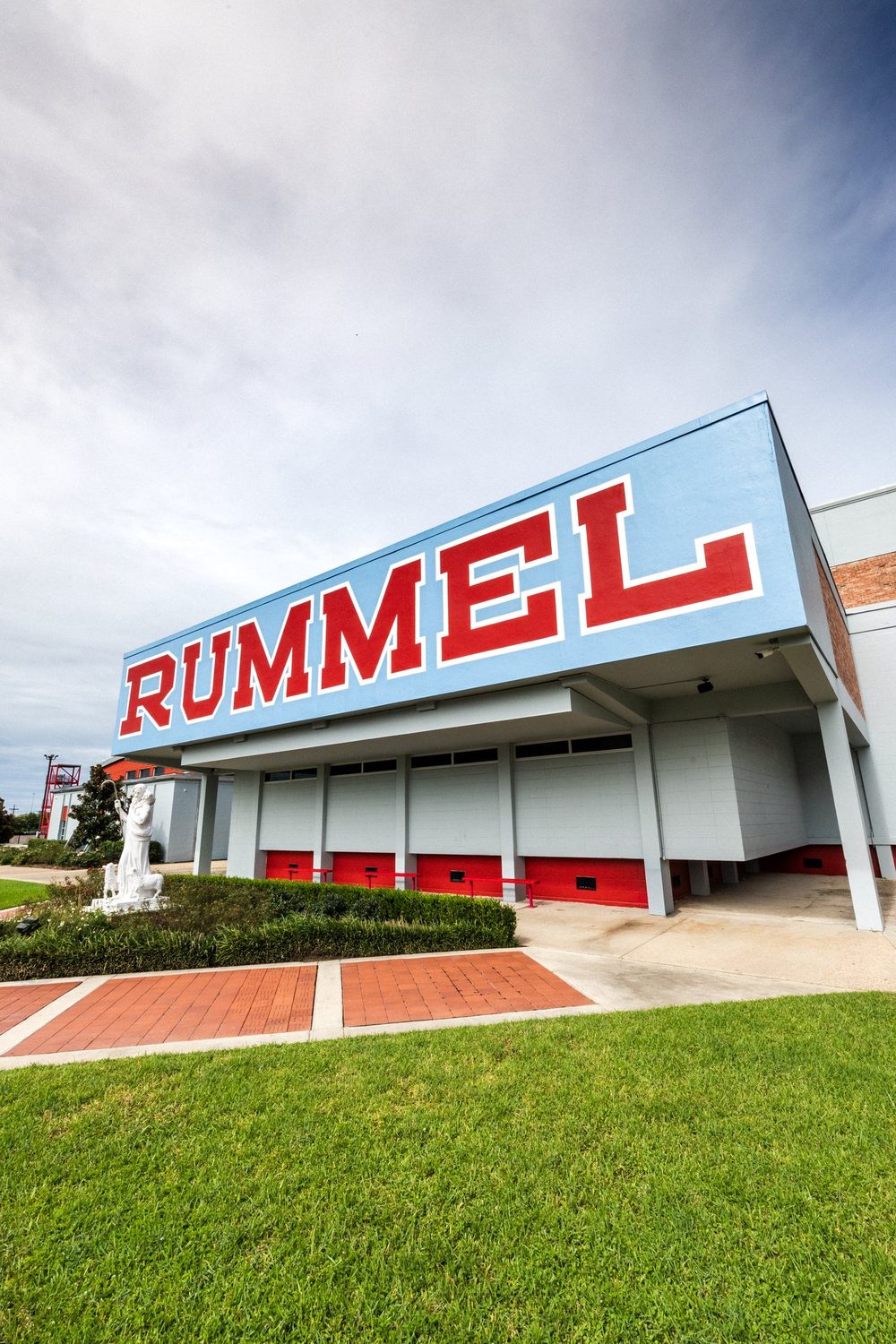 The RUMMEL sign on the front of the school against a blue sky