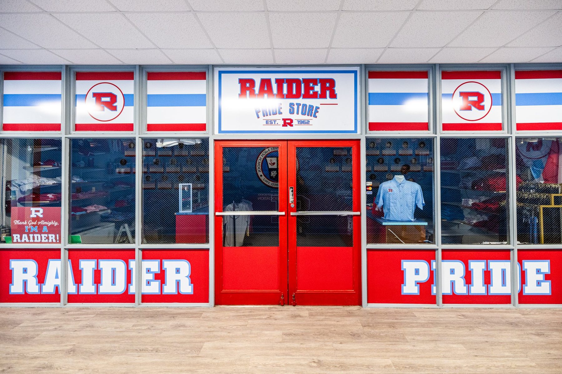The Raider Pride Store, red double doors under a RAIDER PRIDE sign