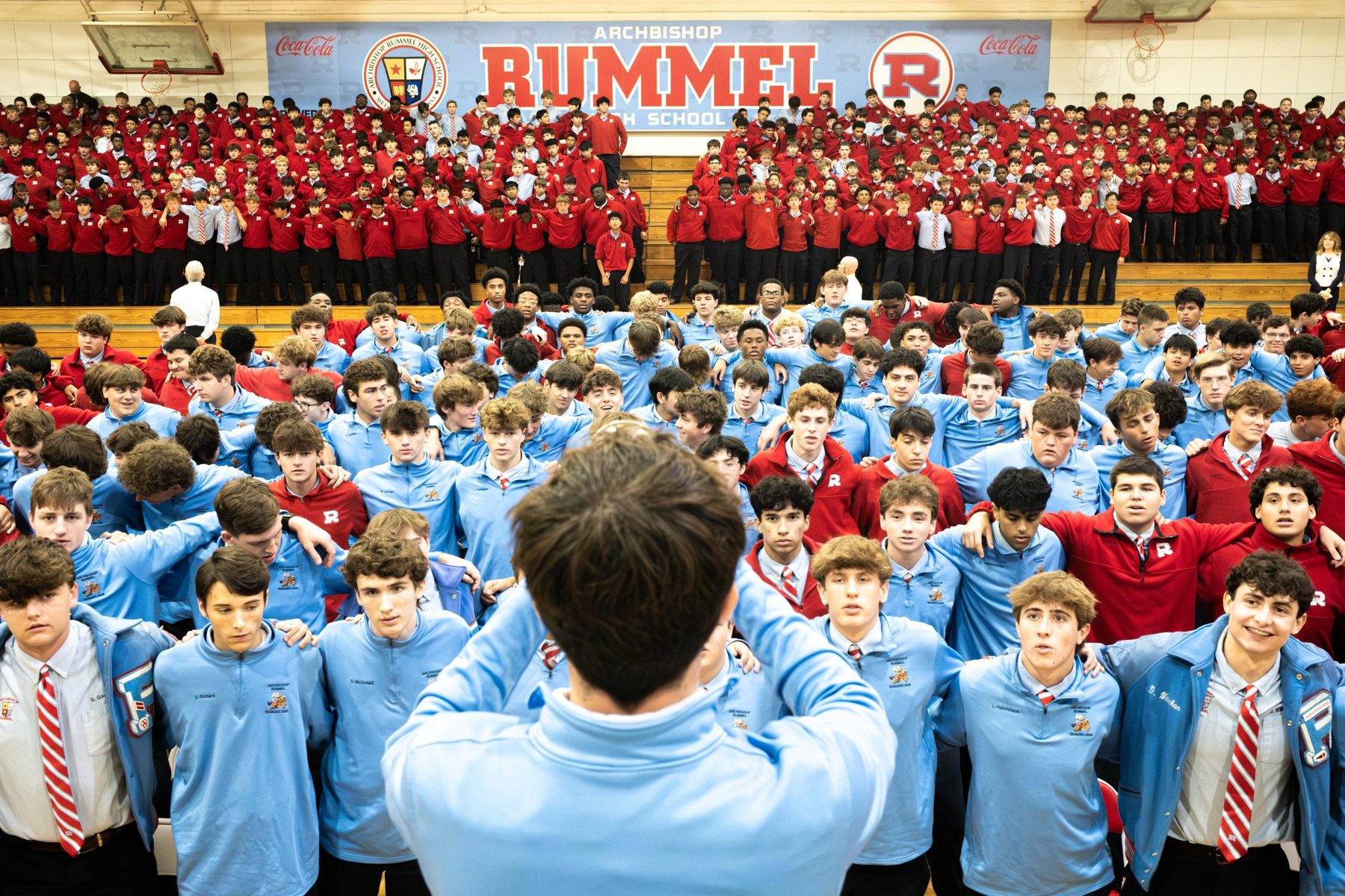 The whole school gathered in the Raider Gym, hands raised, singing