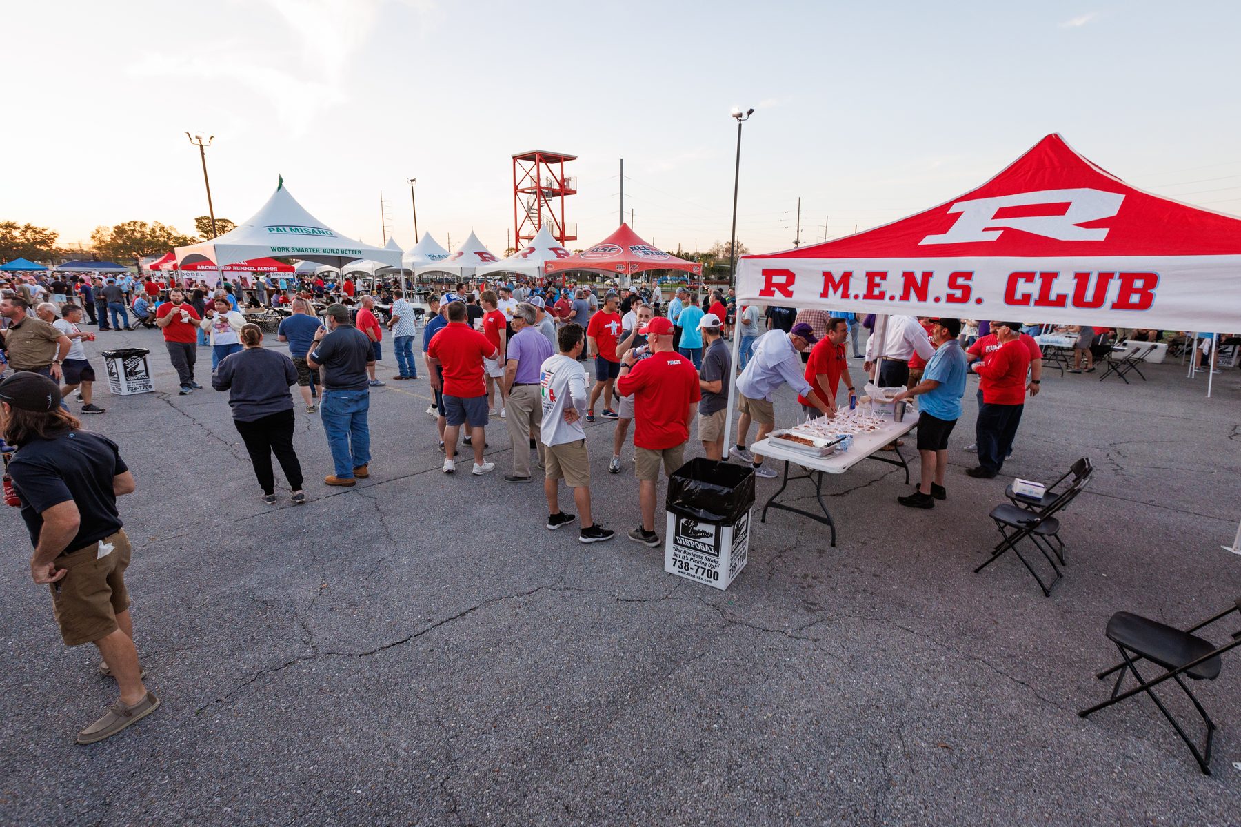 Beast Feast crowds under the tents at dusk on the Rummel campus