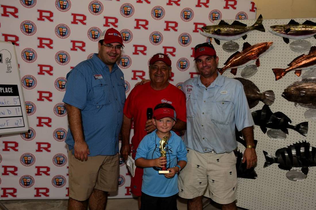 A family at the Fishing Rodeo weigh in
