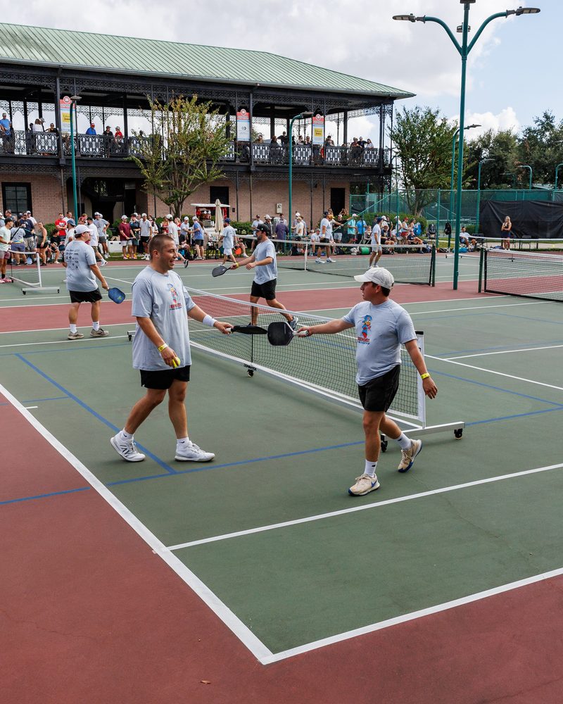 Play across the courts at Chateau with the clubhouse balcony full of spectators behind