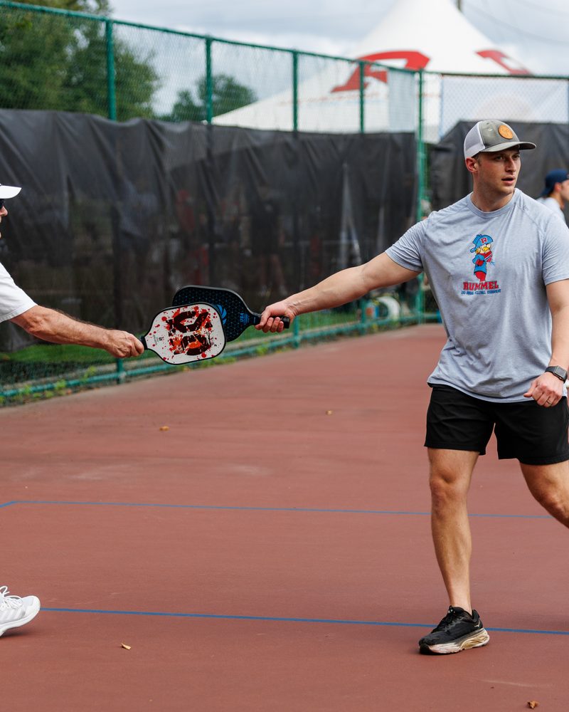 Two Raiders reaching for the ball during a doubles rally