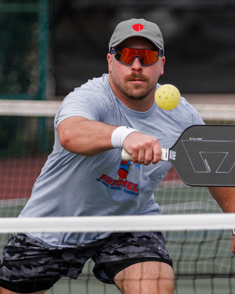 A Raider driving the ball at the net
