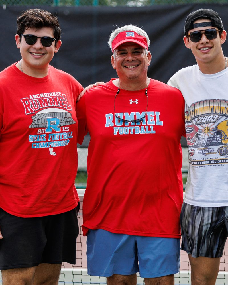 Three Raiders in Rummel shirts between matches at the alumni pickleball tournament