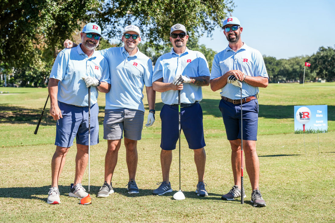 A Raider foursome in Columbia blue Rummel polos and R caps at the tee at the Raider Classic