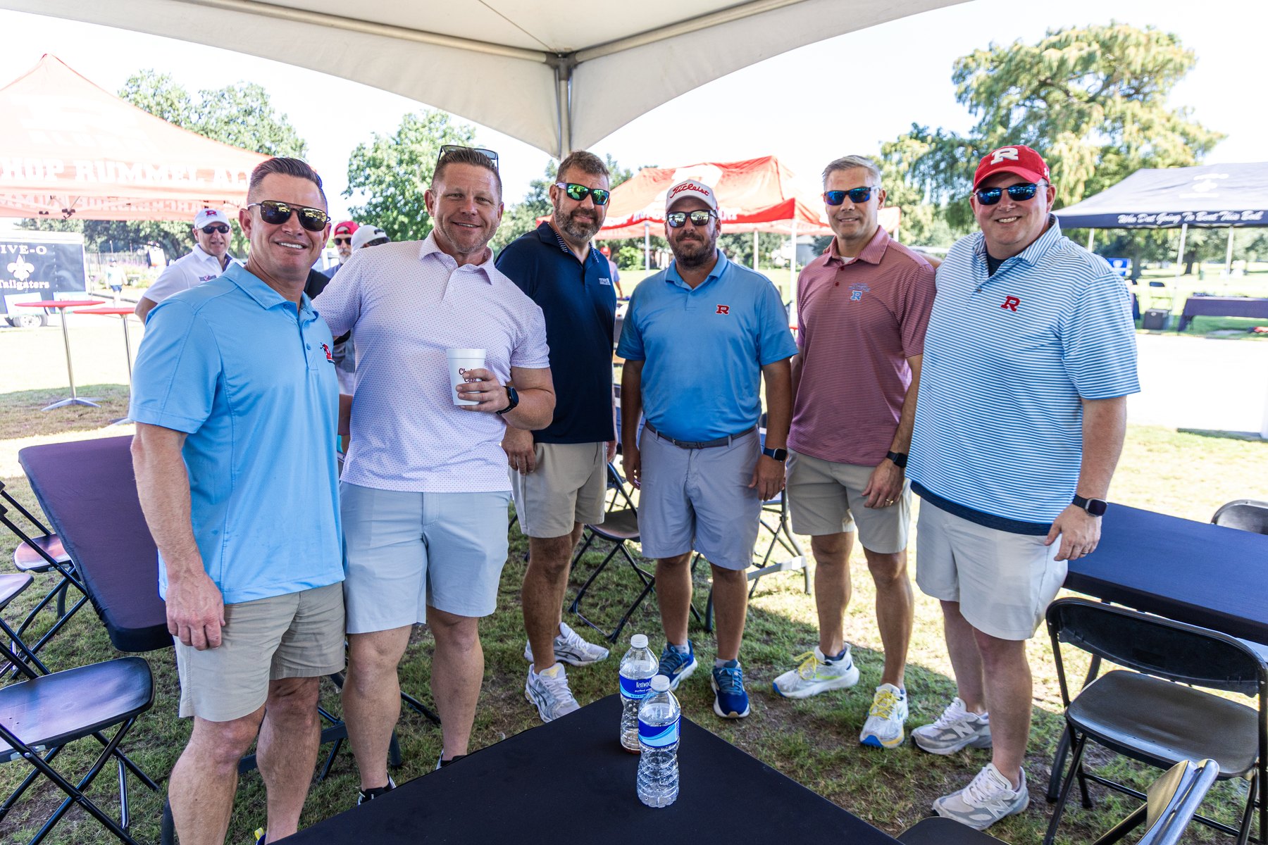 Six alumni gathered under the R tent before the shotgun start