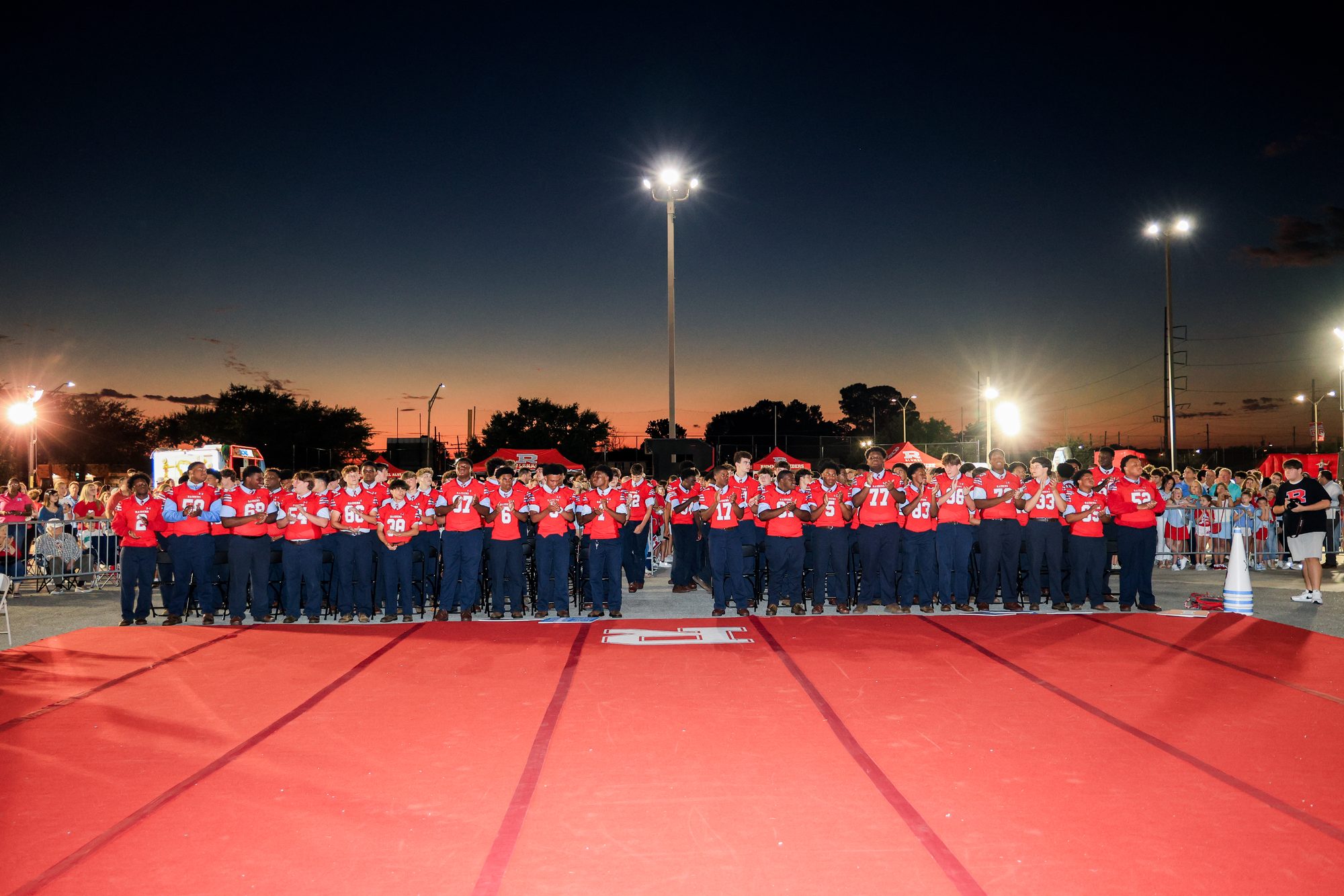 The whole crowd along the red carpet under the lights