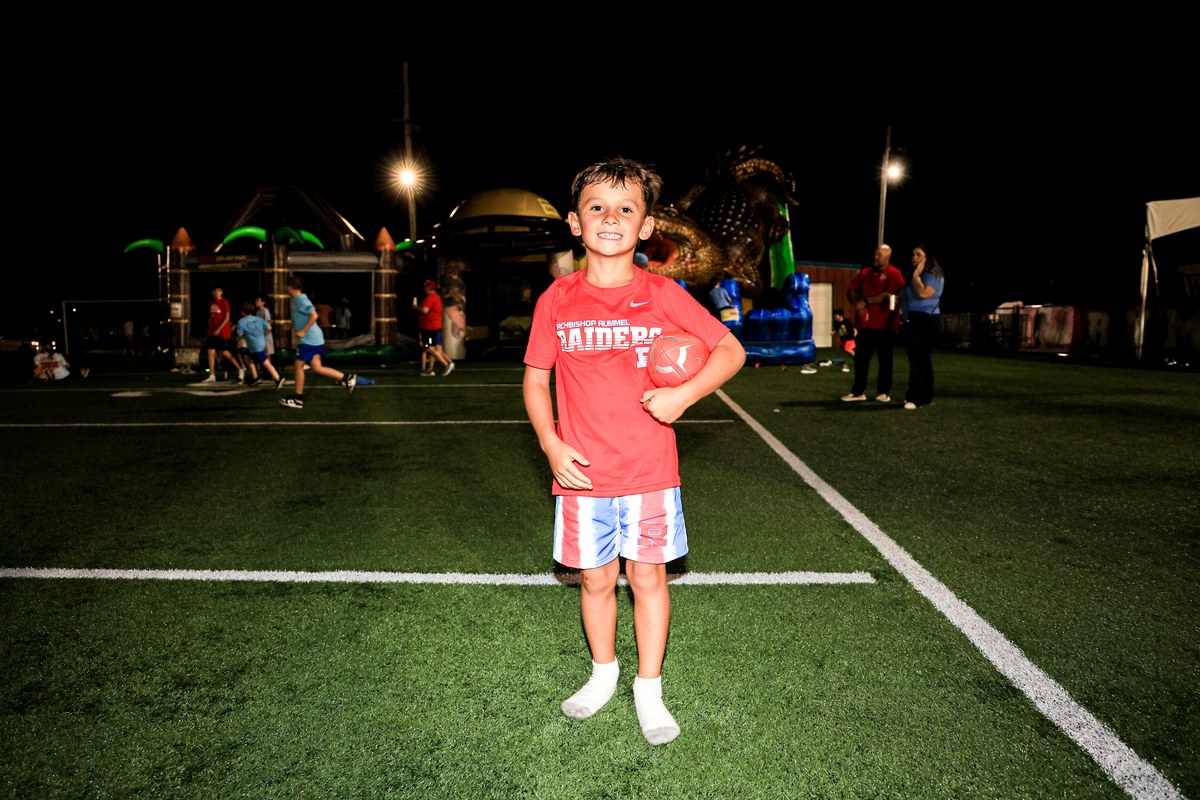 A young Raider out on the field under the lights