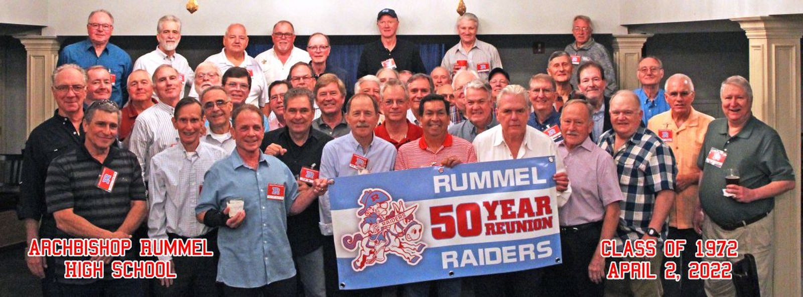 The Class of 1972 at their fifty year reunion, gathered behind a Rummel Raiders banner