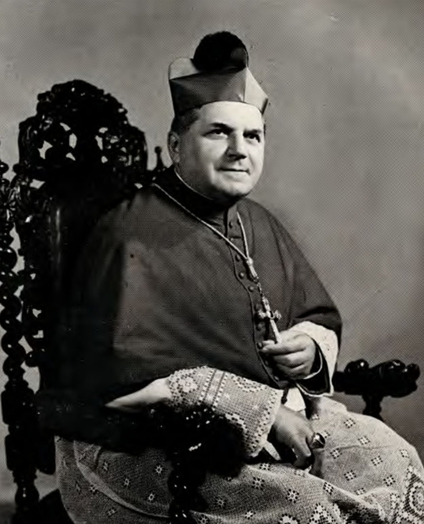Archbishop Joseph Francis Rummel, seated, in biretta and pectoral cross