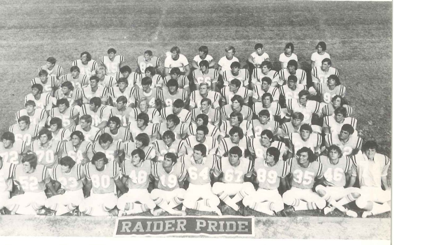 The 1972 Raider football squad seated in rows under a Raider Pride sign