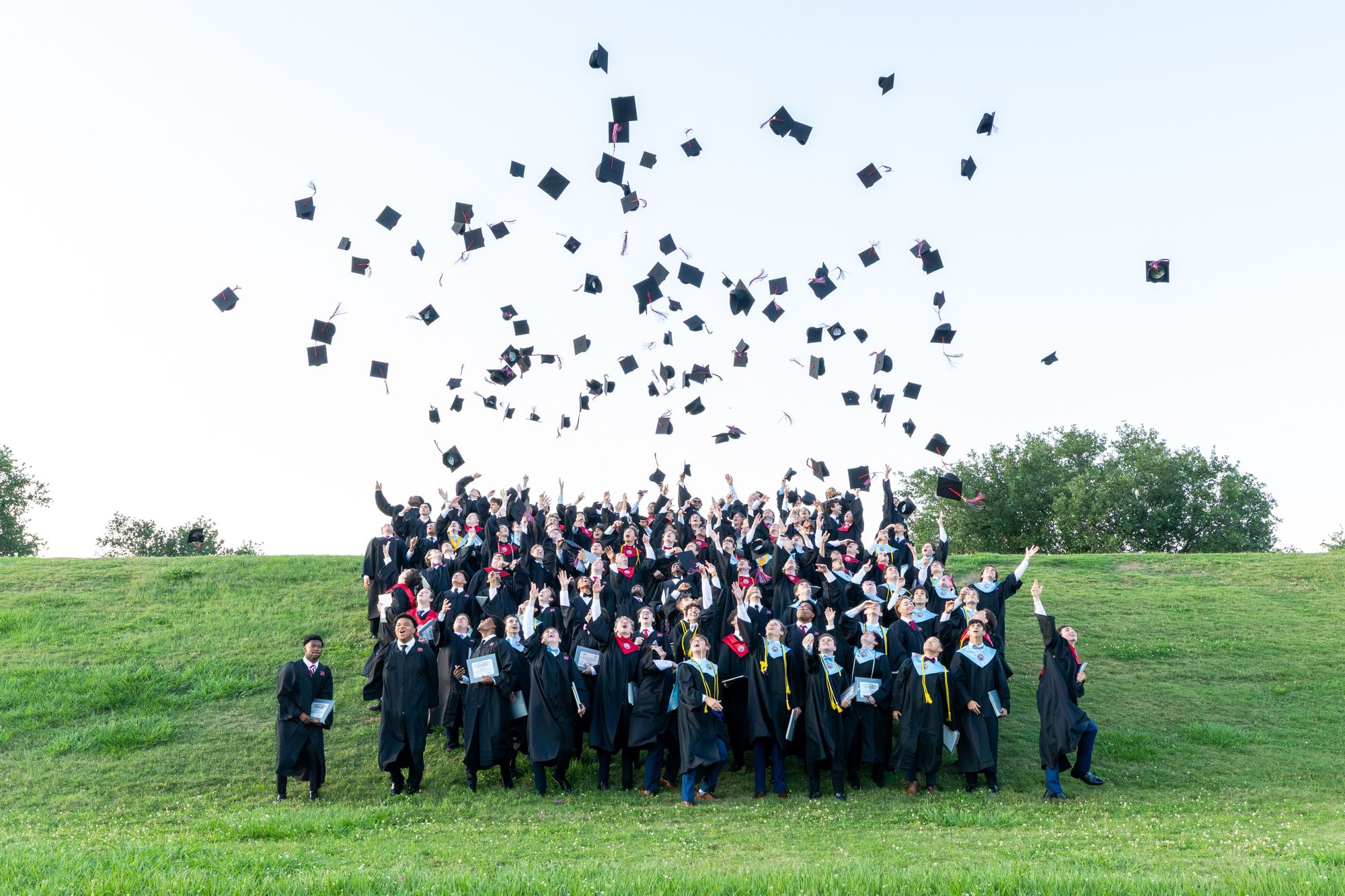 Rummel graduates tossing their caps
