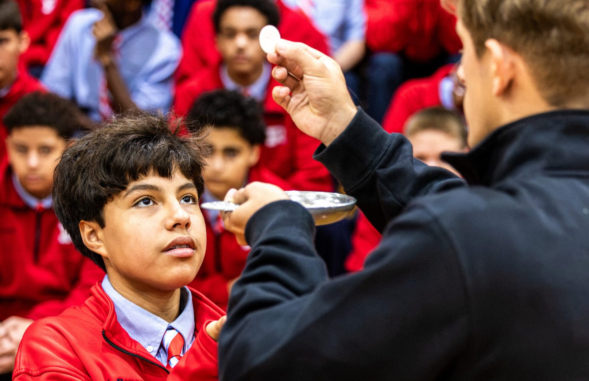 A Rummel student receiving Communion at the all-school Mass