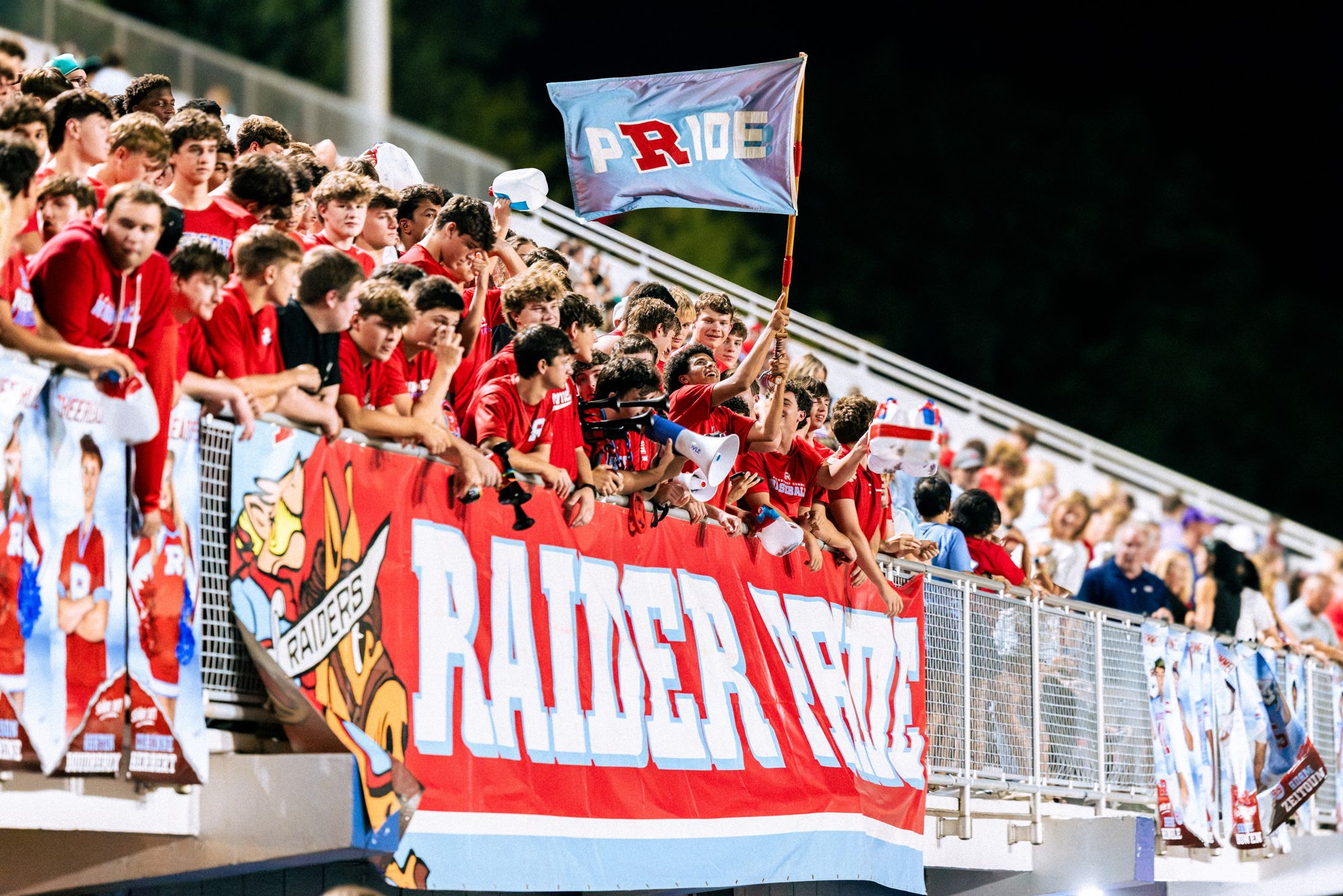 The Rummel student section with the PRIDE flag